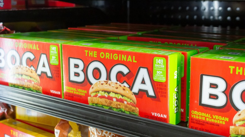 A grocery store freezer with several Boca Burger boxes on a shelf