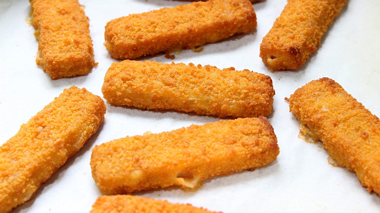 fish sticks arranged on a white tray