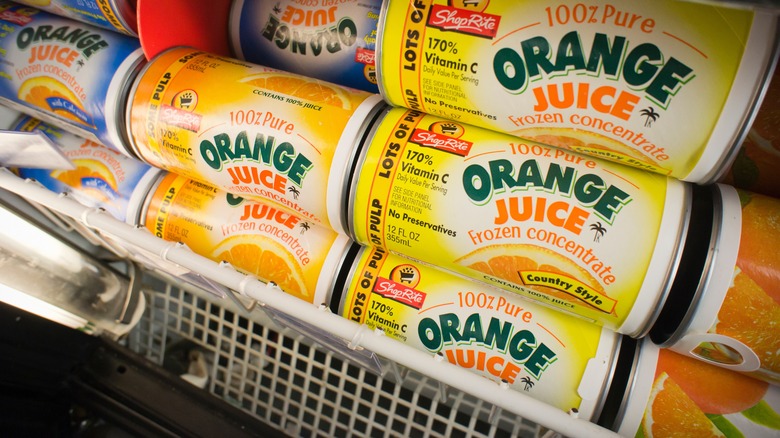 grocery store freezer full of containers of frozen orange juice concentrate.