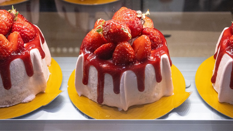 cake with syrup-coated strawberries on top