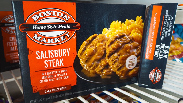 frozen Boston Market Salisbury Steak meal in a grocery store freezer.