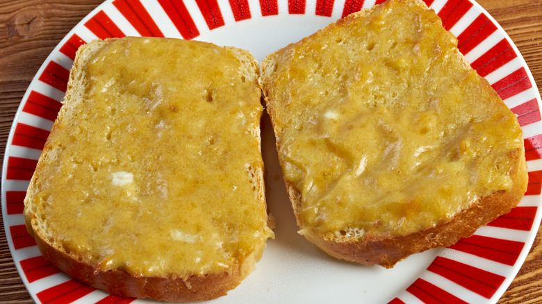 A serving of Welsh rarebit sitting on a plate.
