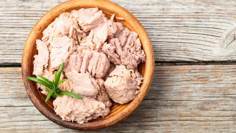 Canned tuna in bowl photography . Top view on rustic background