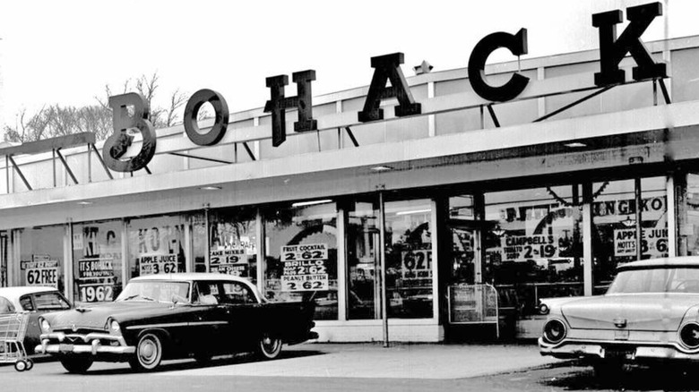 Vintage photo of the Bohack storefront with cars in front parking lot