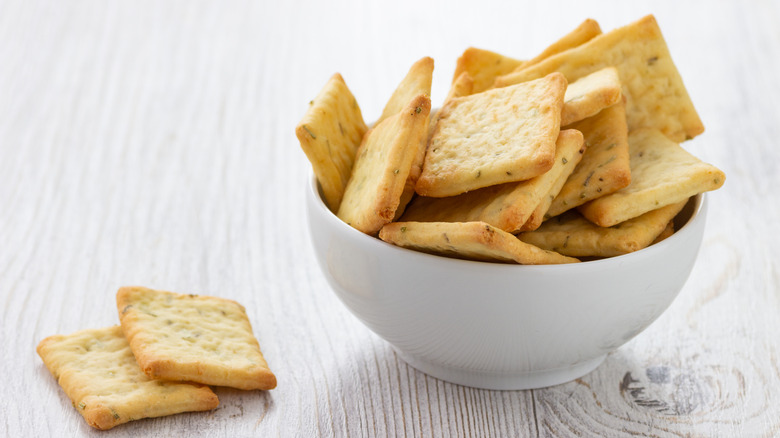 Square crackers in a white bowl