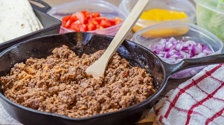 Ground beef cooking in a cast iron skillet
