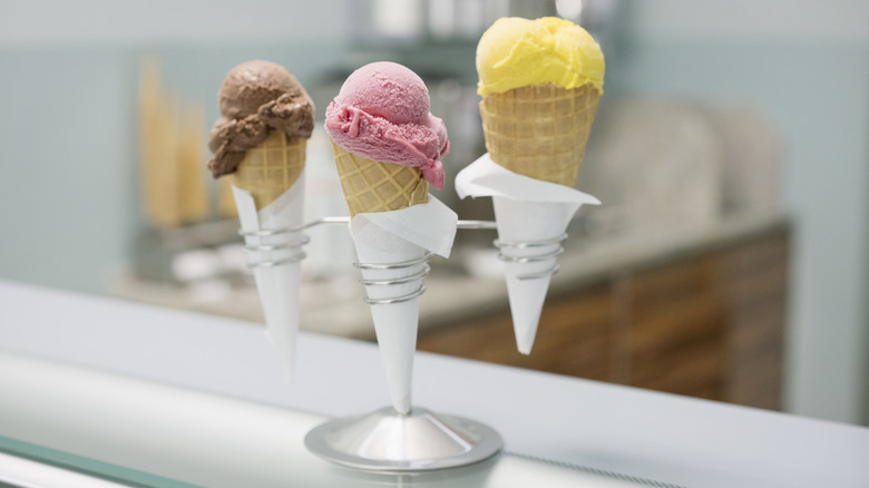 Three ice cream cones with single scoop on silver stand