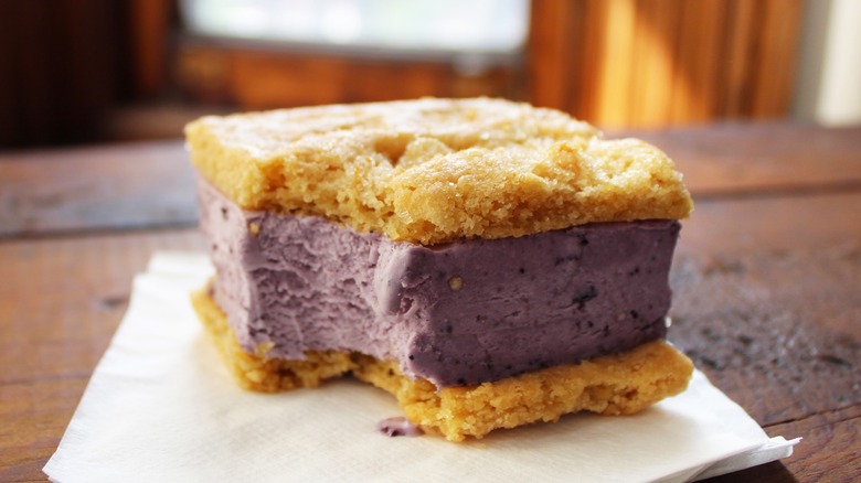 Thick ice cream cookie sandwich filled with blueberry ice cream