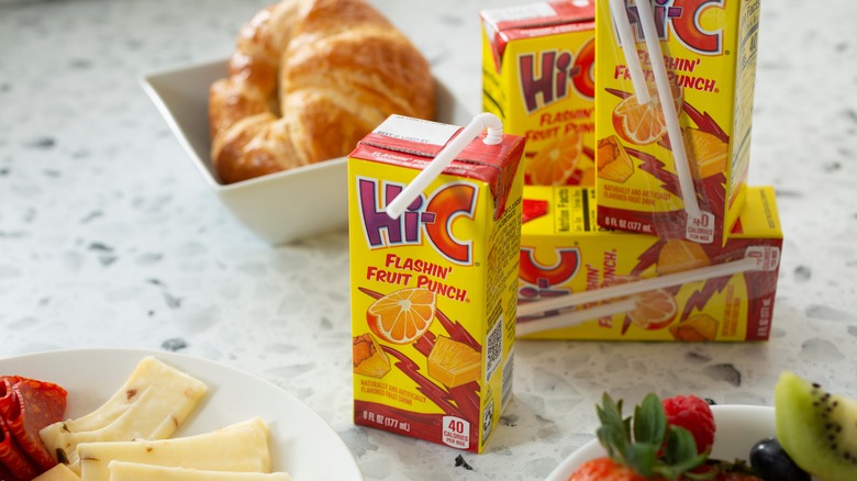 Mini cartons of Hi-C fruit punch next to croissant and fruits