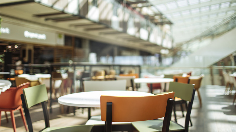 Empty tables at a mall food court