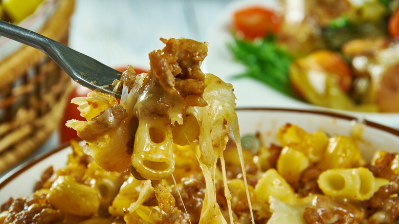 A forkful of Johnny Marzetti being lifted from a larger dish