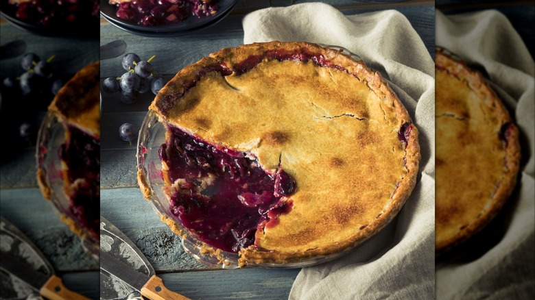 Grape pie with slice taken