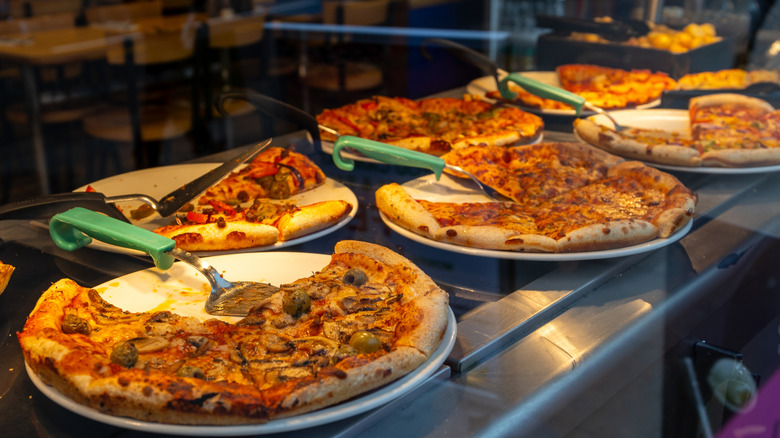 A pizza buffet with lots of pizzas
