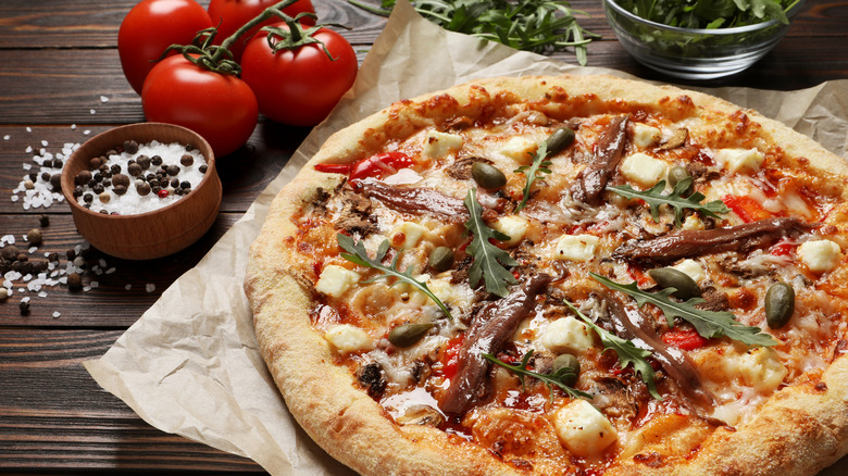 Pizza topped with anchovies and other ingredients