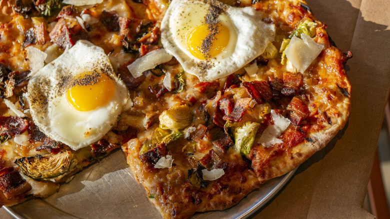 Cooked eggs on top of pizza