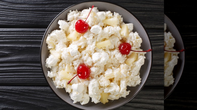 Frog eye salad in a bowl with marshmallows and cherries on top