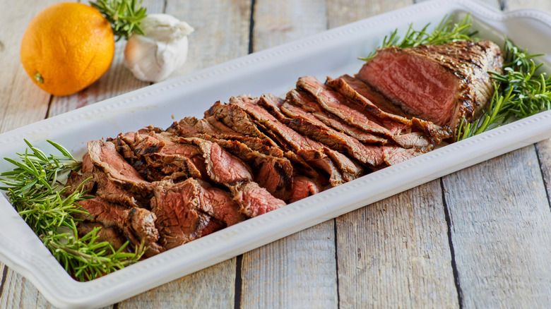 London broil sliced steak in a tray