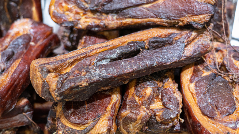 Traditional Chinese cured pork presented in a pile.