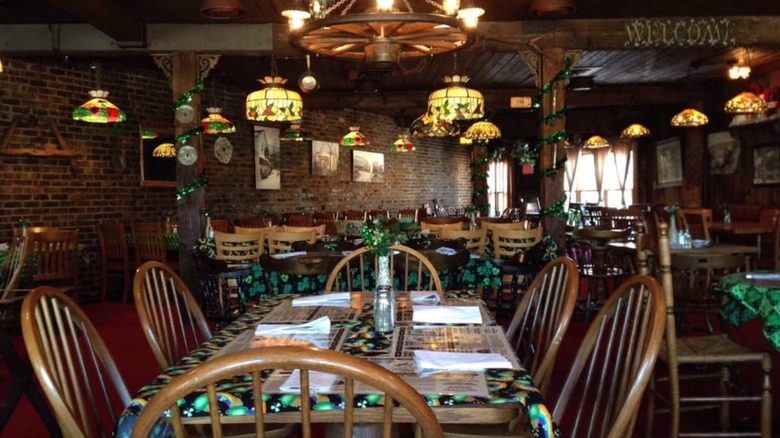 Interior of The Village Tavern decked out with St. Patrick's Day decorations and Tiffany lamps