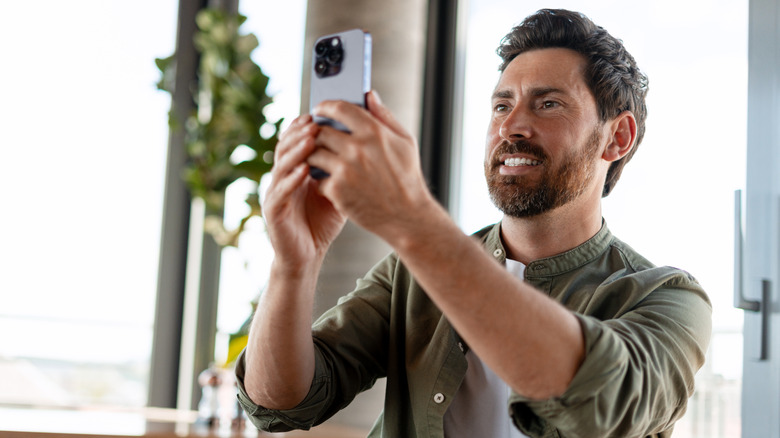 A man filming inside a restaurant.