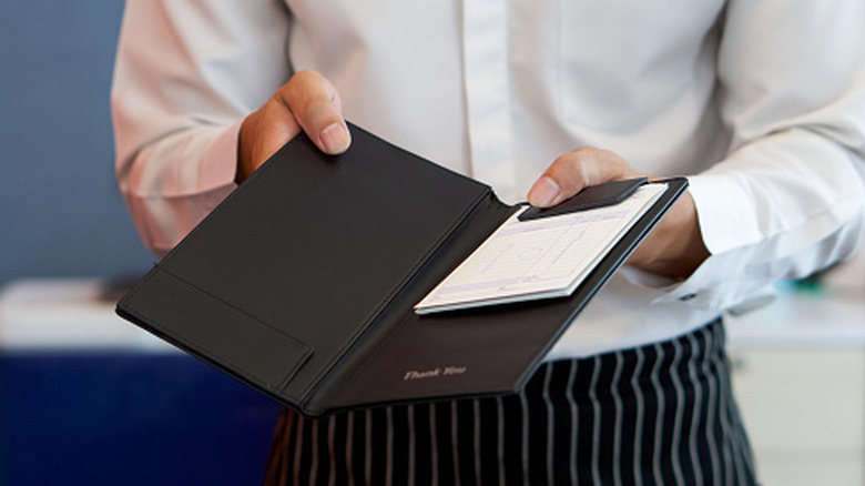 A server presenting a bill.