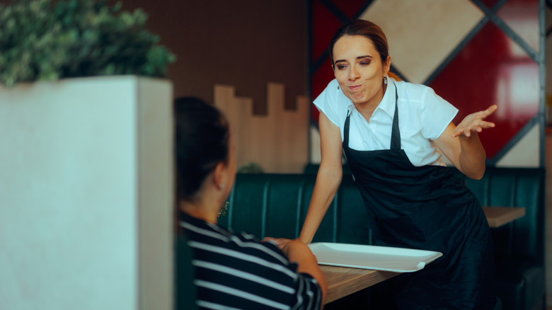 A server making a face at a customer.