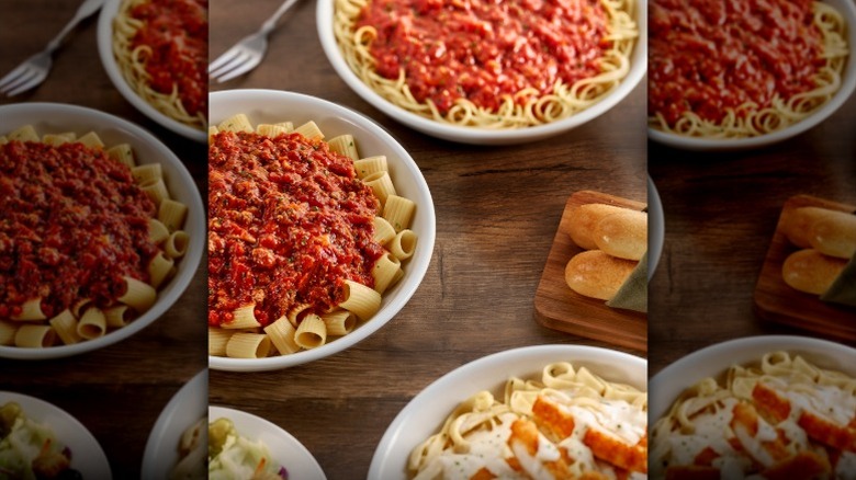 Bowls of Olive Garden pasta on a table.