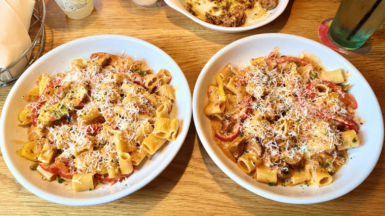 Two bowls of Rigatoni pastas on a table