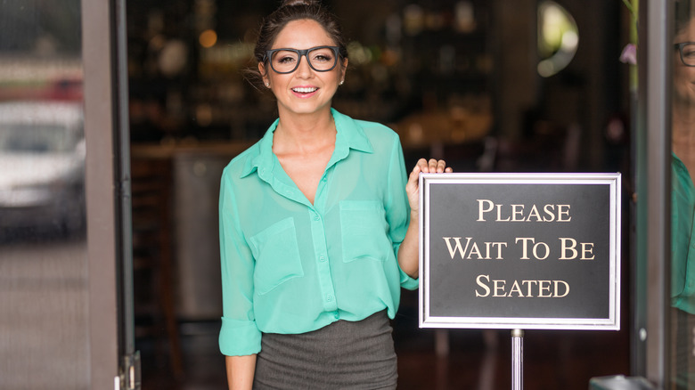 Young woman at the front of a upscale restaurant