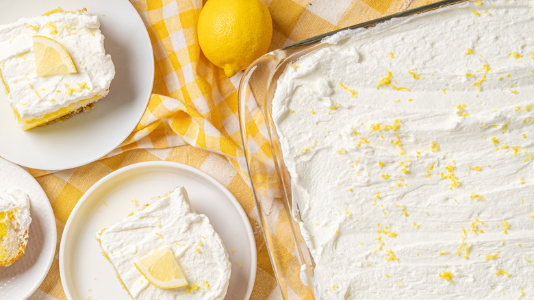 Top view of lemon and whipped cream dessert in glass pan