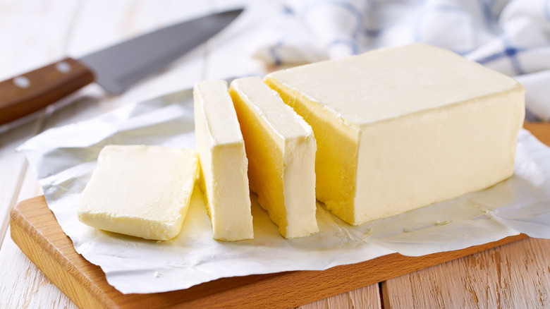 A block of butter cut into slices.