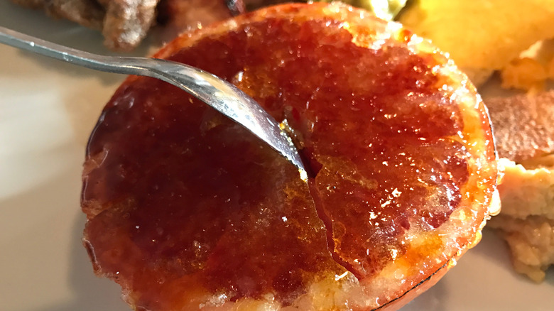 Bruleed grapefruit with a spoon in it.