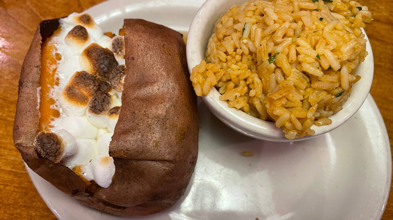Texas Roadhouse sides: a loaded sweet potato and seasoned rice
