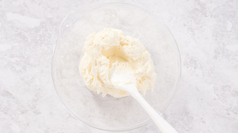 Glass bowl of store-bought vanilla frosting
