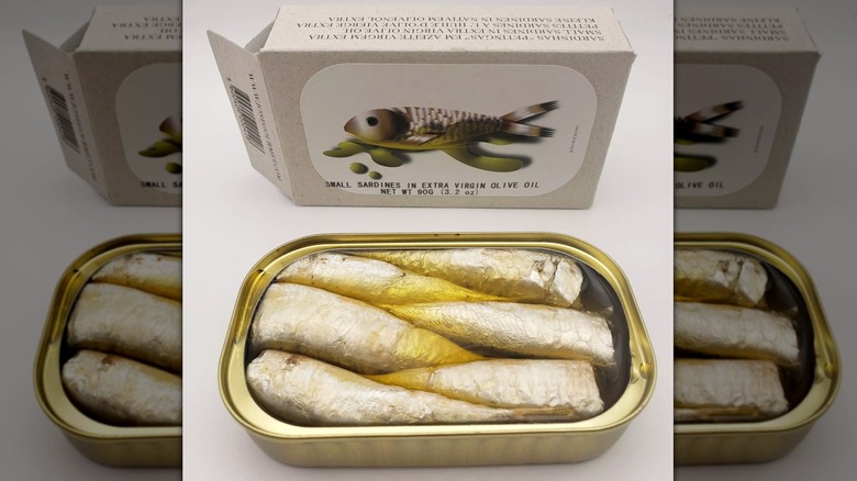Opened tin of Jose Gourmet Small Sardines in Extra Virgin Olive Oil and box on white background
