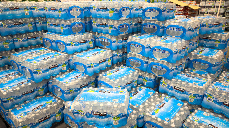 A huge stack of cases of Kirkland Signature bottled water in a Costco store