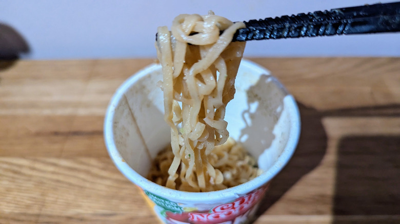 chopsticks holding turkey dinner noodles
