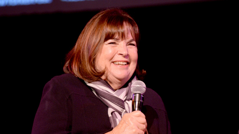 Ina Garten holding a microphone laughing