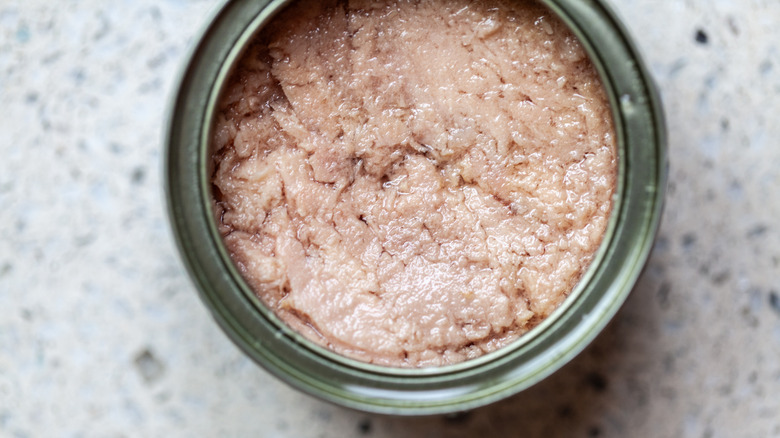 An opened can of tuna in oil