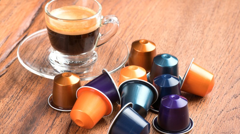 Nespresso pods and espresso in a glass mug