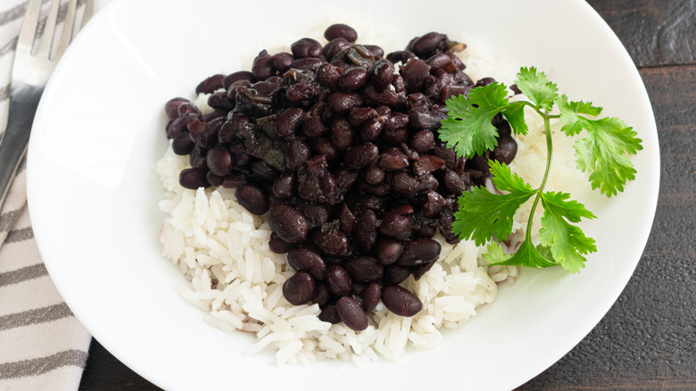 bowl of white rice with black beans on top