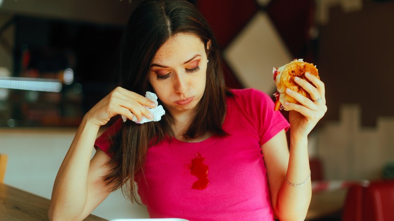 Messy sandwich dripped on someone's shirt
