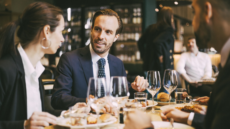 People in suits at a restaraunt