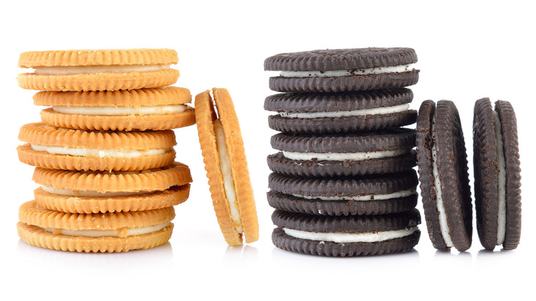 Chocolate and vanilla sandwich cookies on white background