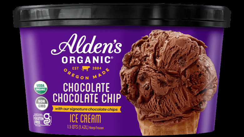 A purple tub of Alden's organic chocolate chocolate chip ice cream on a dark background.