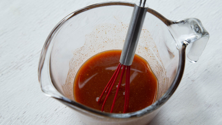 red sauce in a glass measuring cup