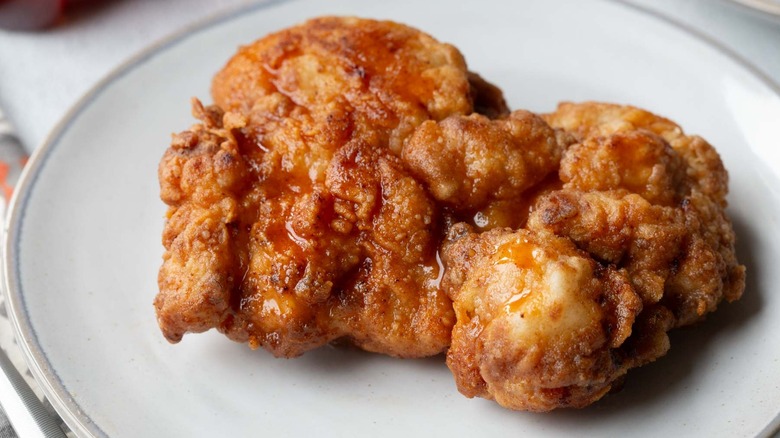 fried chicken strip on a white plate