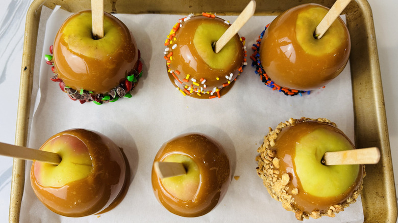 Caramel apples on baking sheet