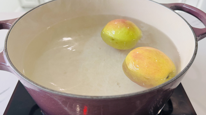 Apples floating in hot water