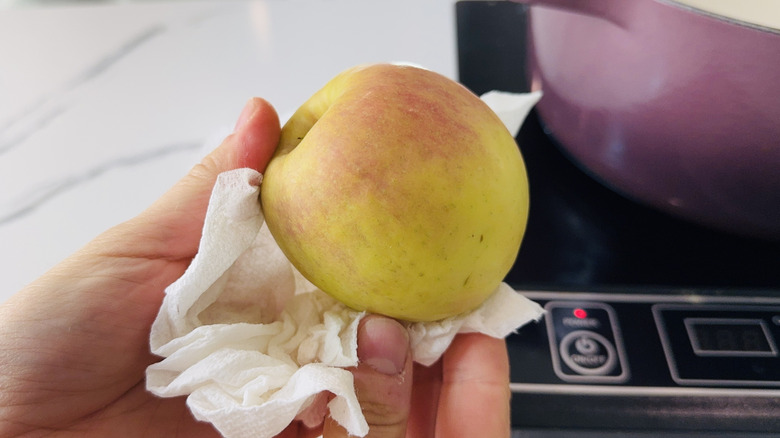 Rubbing apple with a paper towel